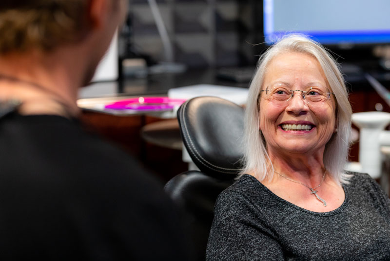 Stephanie, A Dental Implant And Full Mouth Restoration Patient, Smiling During Her Consultation