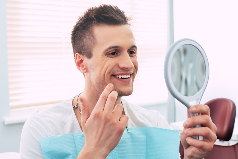 patient smiling after dental cosmetic procedure