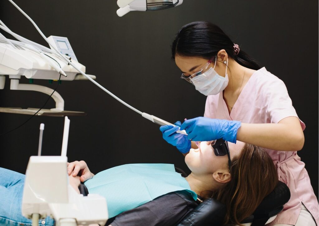 Patient receiving a dental examination during a consultation about dental implants, discussing the benefits and considerations of implant treatment.