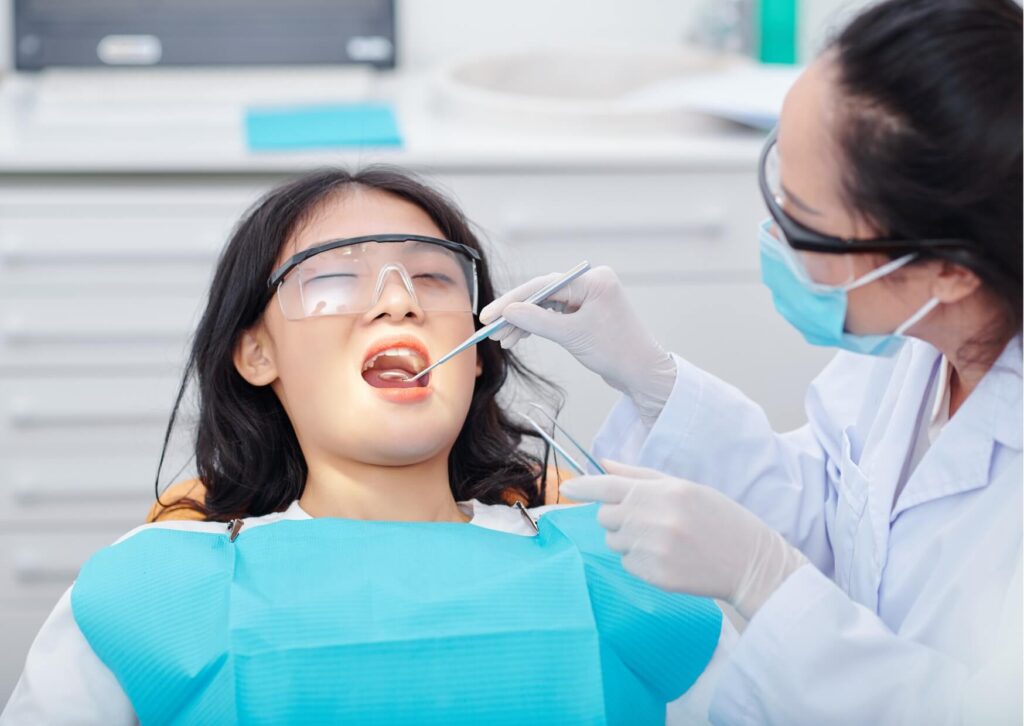 Patient receiving a dental examination to identify what a cavity looks like and determine the best treatment option.